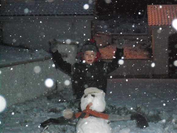 Conor, aged 7, with the snowman he built in Fintown!