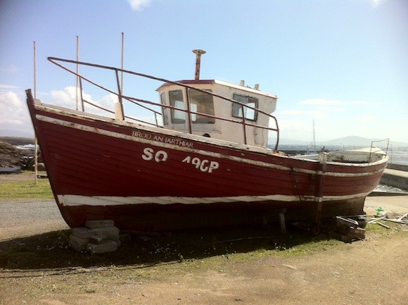 A fishing boat parked up on the pier.