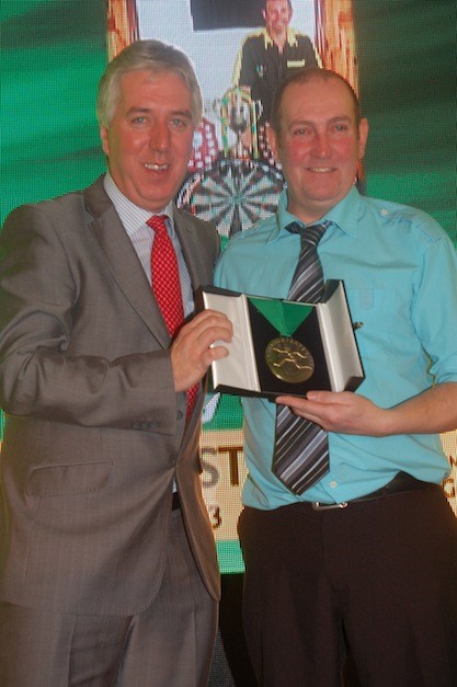 Charlie Grant receives his awards in the darts category.