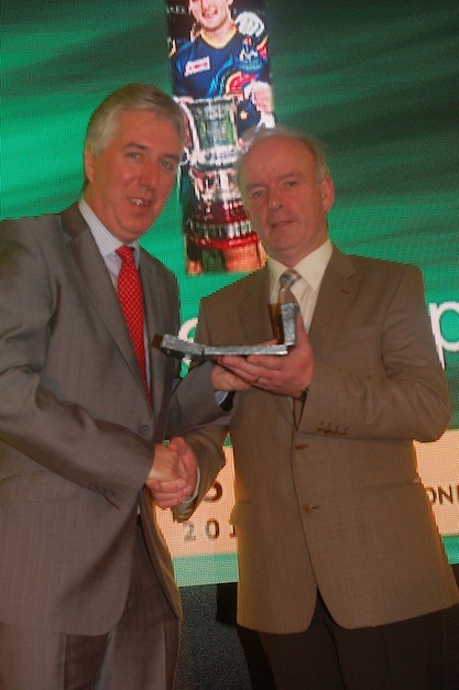 Mick Murphy accepts the GAA award on behalf of his son Michael from John Delaney