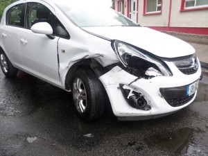 The damage caused to the car belonging to Donna's father in law (left). Above the damage to the front of the house